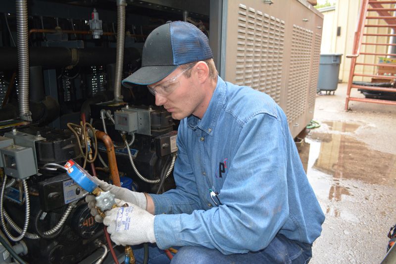 service technician repairing hvac unit